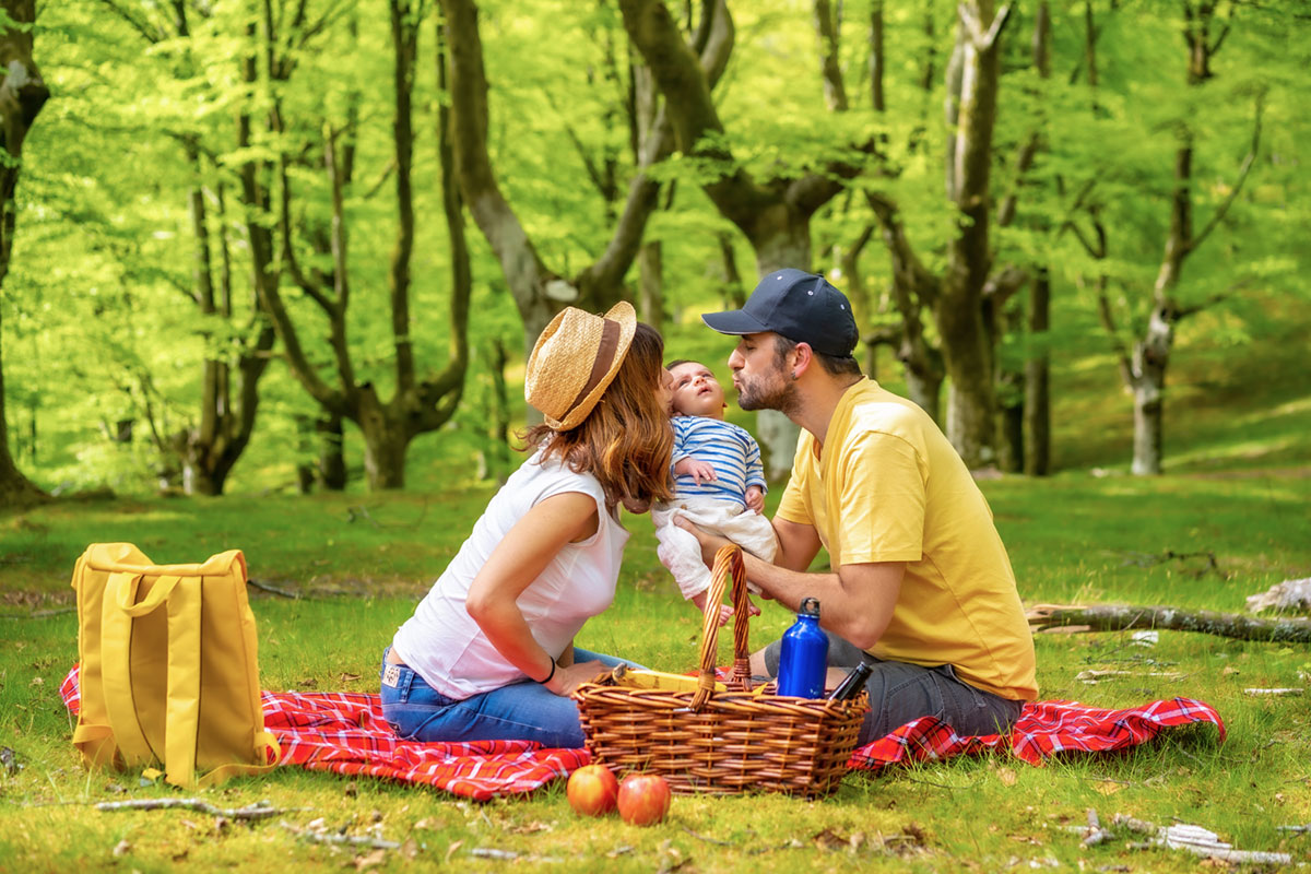 A Family On A Picnic Day With Their Newborn Son