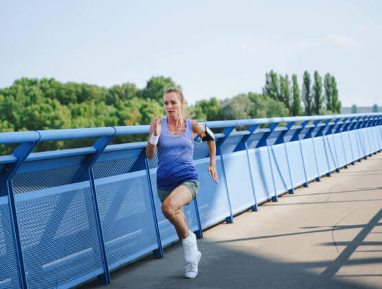 Mid Adult Woman Running Outdoors In City Healthy